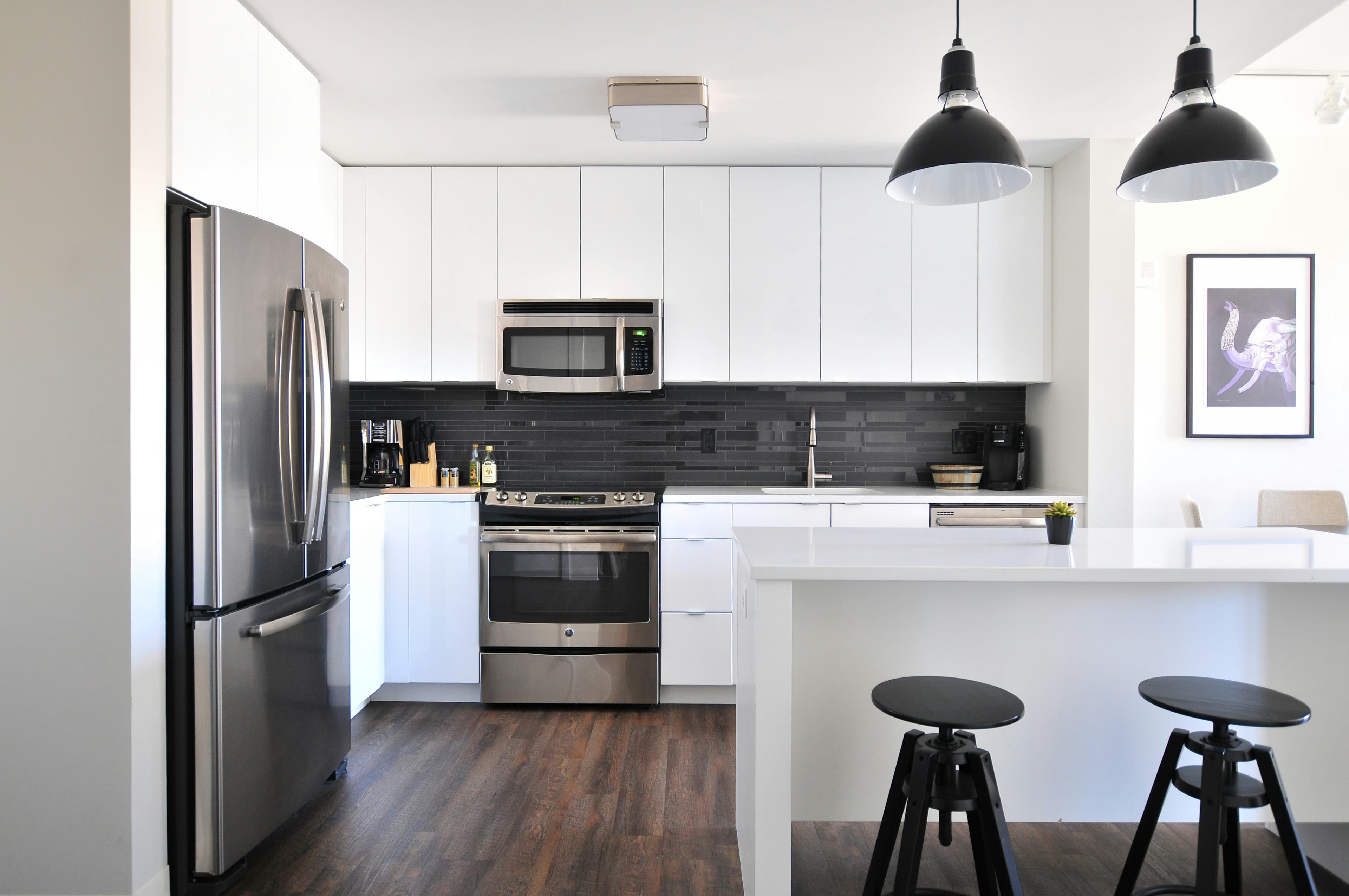 A renovated contemporary kitchen with refined finishes and warm natural light.